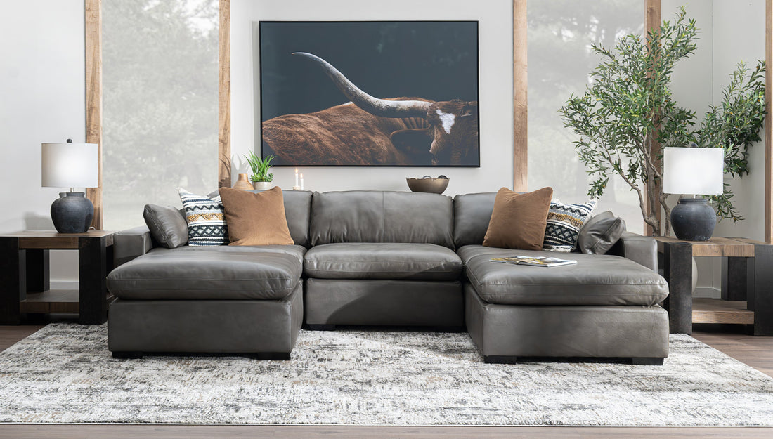 Living room with gray sectional and large art on the wall